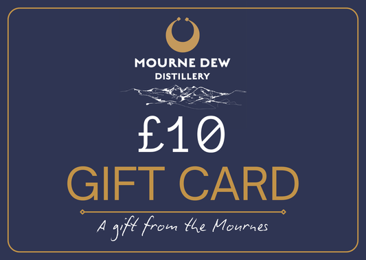 A dark navy blue gift card with a gold border, featuring the Mourne Dew Distillery logo and text that reads '£10 GIFT CARD' and 'A gift from the Mournes'.