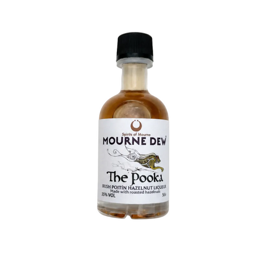 A small glass bottle of Mourne Dew 'The Pooka' Irish Poitín Hazelnut Liqueur, featuring amber-brown liquid, a white label with navy text, and a black cap, set against a plain white background
